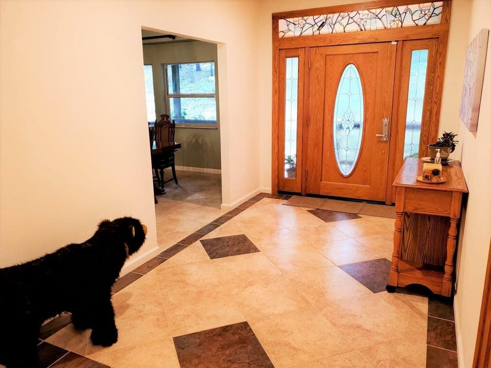 The large entryway with beautiful marble flooring and custom stain glass.