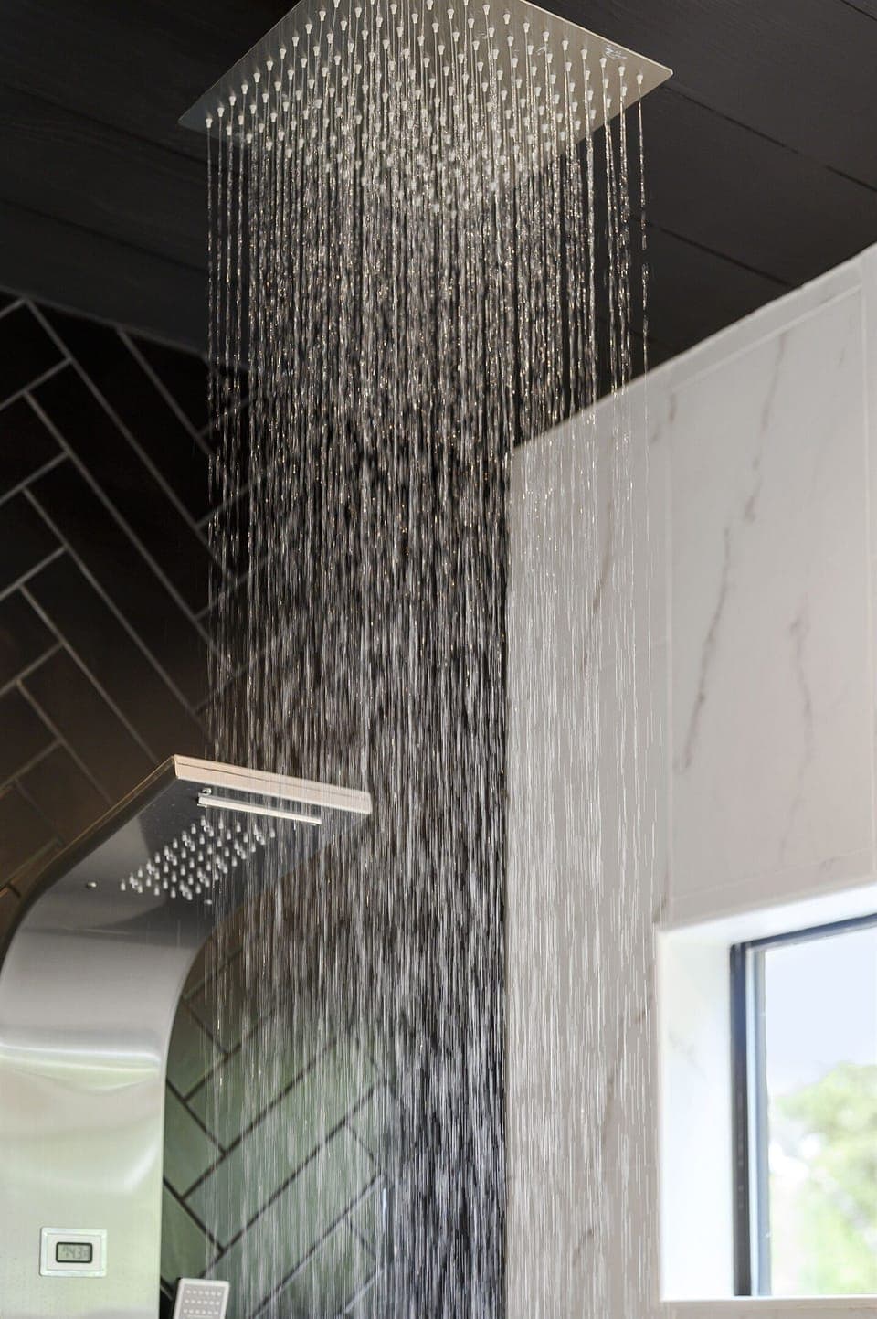 Close-up of a rainfall shower with a sleek, modern design, offering a relaxing and rejuvenating experience. Perfect for a spa-like retreat.