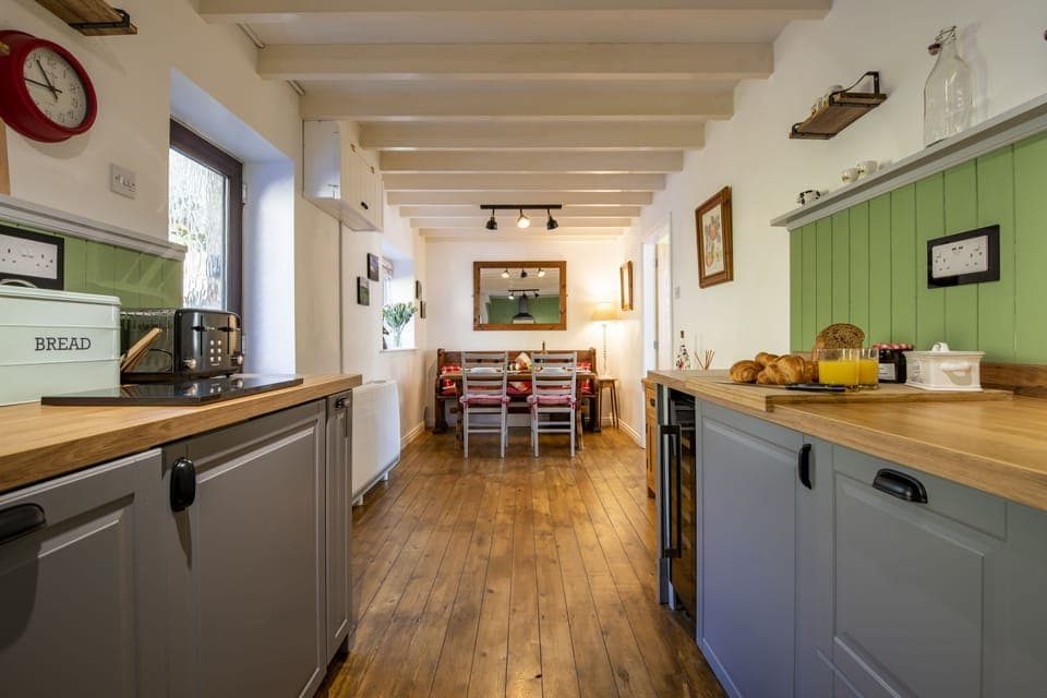 Ground floor: Dining kitchen with rear door leading out to the patio area