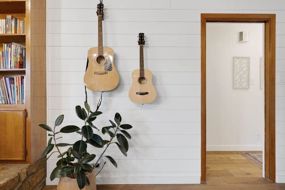 Guitars and books in the living room invite you to strum a tune, read, and truly unwind at Serenity on the San Gabriel.