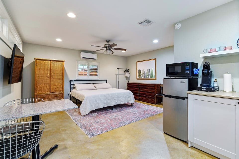 Main studio area includes king bed, tv, kitchenette & dining table. 