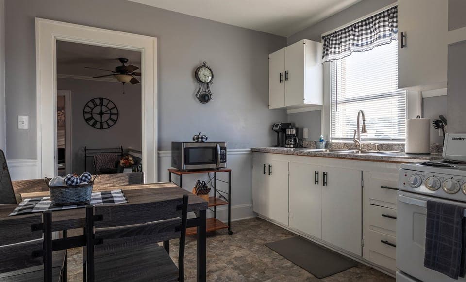 The dining table and chairs are located in the eat-in kitchen.