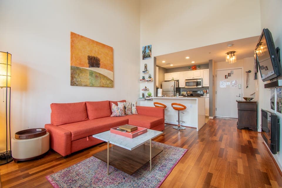Spacious living room with sleeper sofa, dining table, fireplace and smart TV.