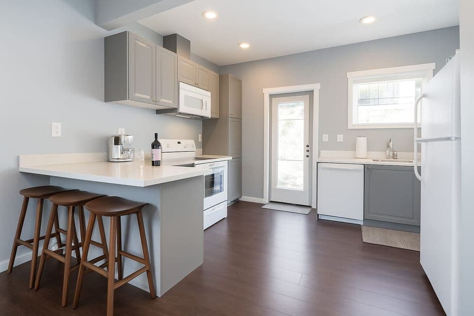 Sleek and simple kitchen designed for easy meal prep and comfortable stays.