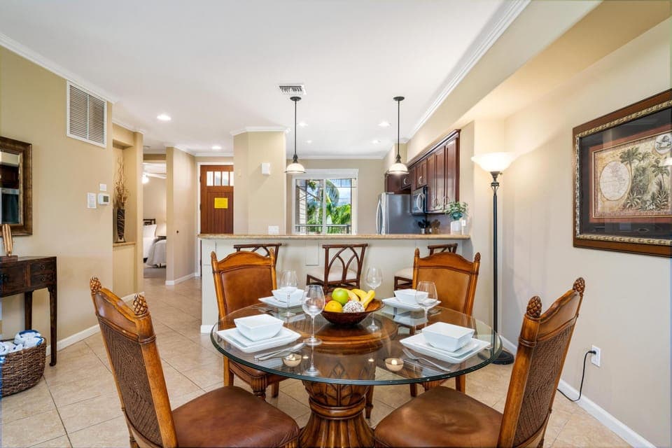 - Stylish dining setup framed by pendant lights and natural wood accents throughout - Kitchen breakfast bar offers extra seating and easy serving options - Perfect spot to share meals, play games, or plan your island adventures