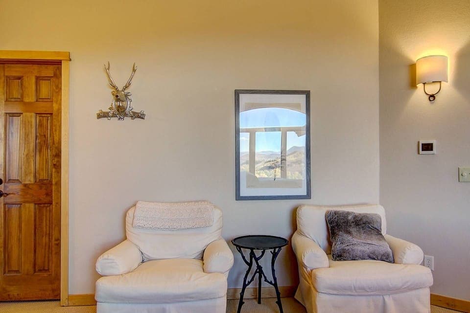 The master bedroom includes a charming seating nook, offering a peaceful spot to unwind with a book or sip your favorite drink.