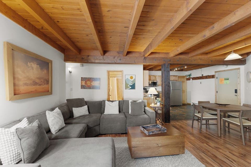 Cozy living area with flat screen TV, gas fireplace, ample seating and access to the private back deck.