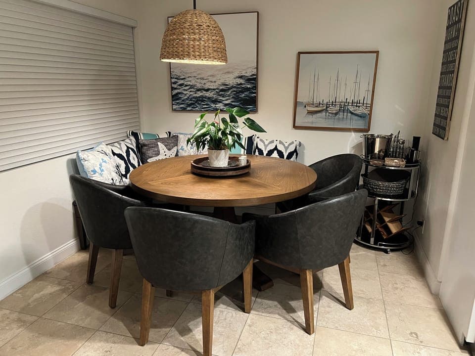 4 captain’s chairs with adjacent bench seating at dining area.