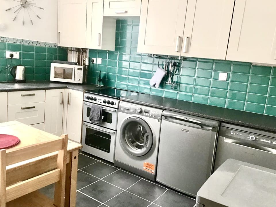 Spacious kitchen with dishwasher, washing machine, freezer and separate fridge.