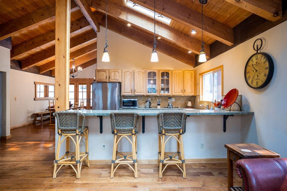 The spacious living room and kitchen are seamlessly connected, offering a bar seating area that's perfect for mixing drinks or casual meals