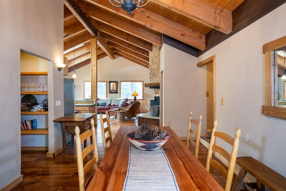 This large dining setup features a table that comfortably seats eight, making it ideal for everything from casual breakfasts to formal dinners