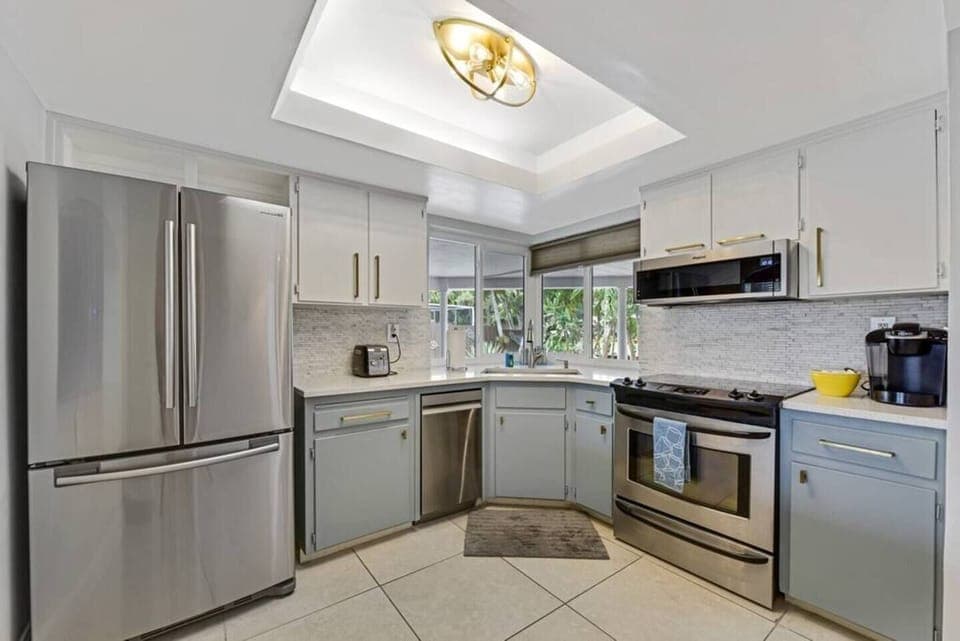 The kitchen is stocked with a full set of appliances including a refrigerator and basic kitchen utensils. 