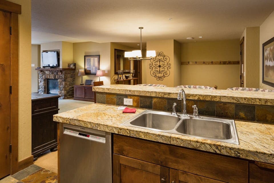 Kitchen and bar area. Fully stocked with cookware and dishware.