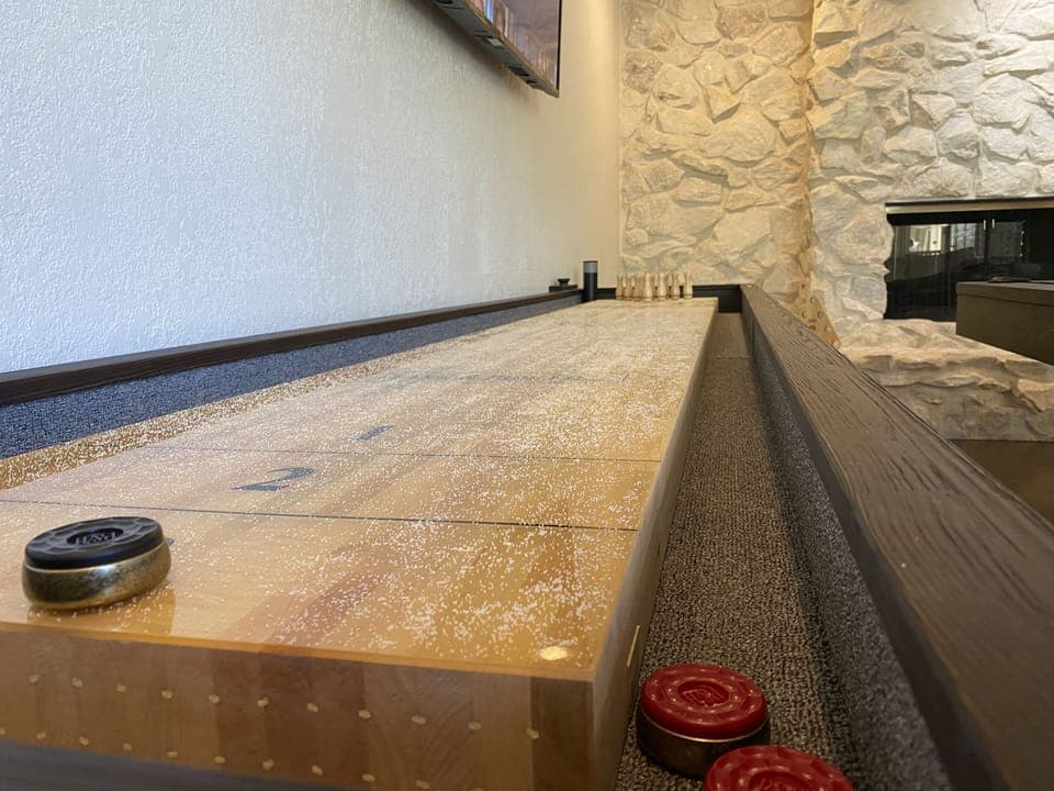 Shuffleboard with a view of the double-sided gas fireplace.