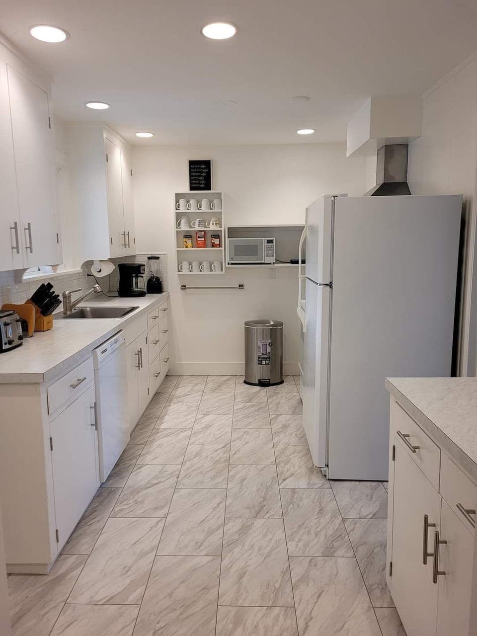 Galley kitchen, well appointed with ample dishes, silverware and cookware.