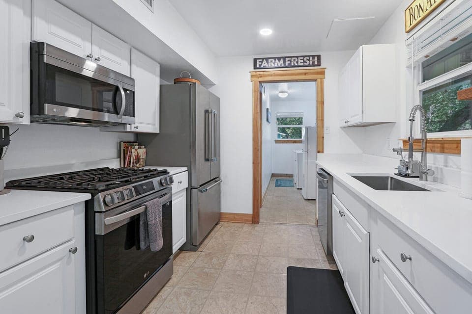 Full kitchen with refrigerator, oven, coffee maker, and microwave