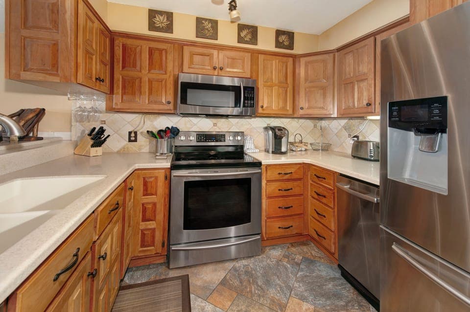 Full size kitchen with stainless steel appliances.