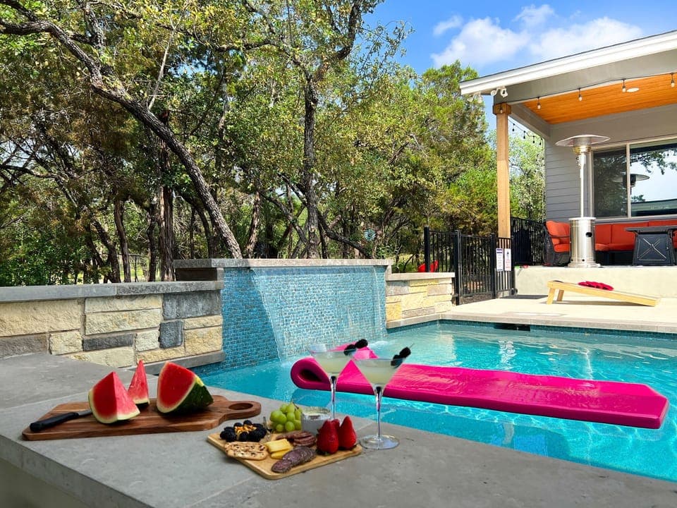 Welcome to Lago Vista Vibe - a spectacular Lake Travis acreage home with top amenities.  Swim up to the pool bar for some refreshments.