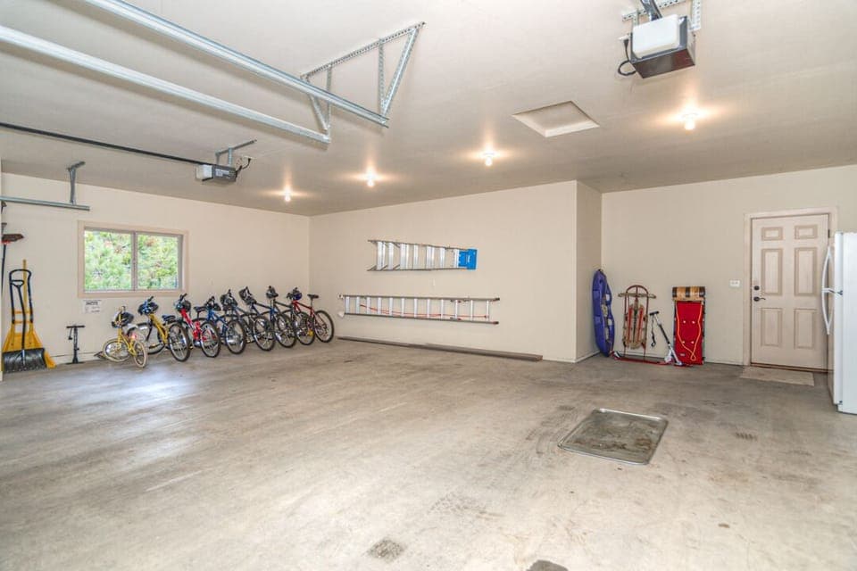 Large 3 car garage showing bikes and snow toys.