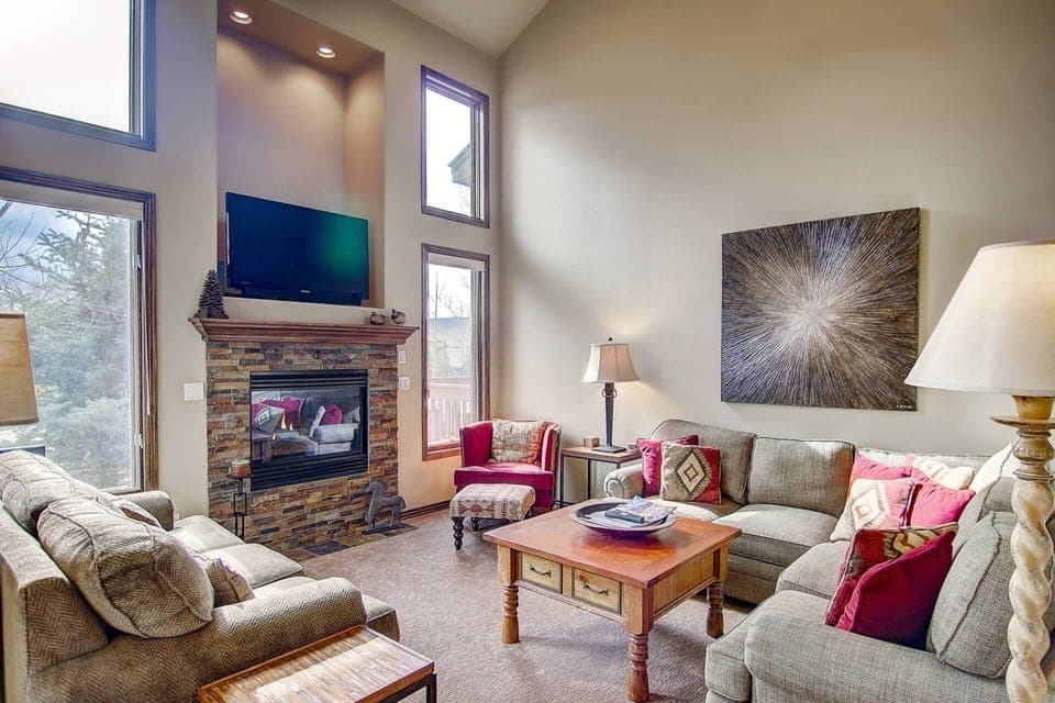 Spacious living room with fireplace and TV, right off of the dining and kitchen