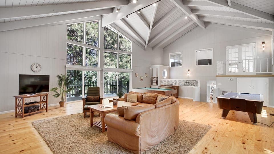 Living room with pool table, foosball table, Roku TV, large coffee table for board games