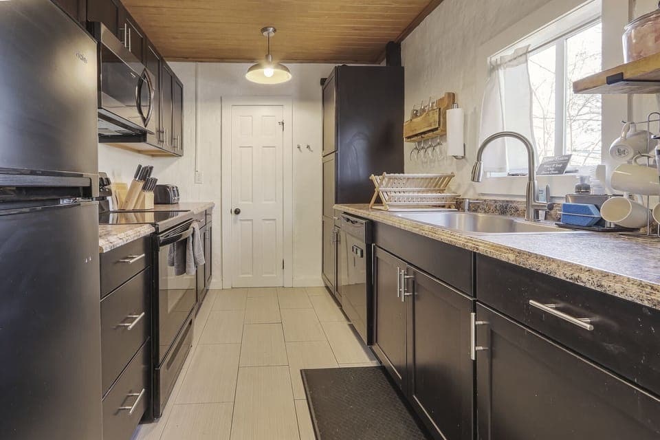 Full kitchen with stove, oven, refrigerator, and coffee maker