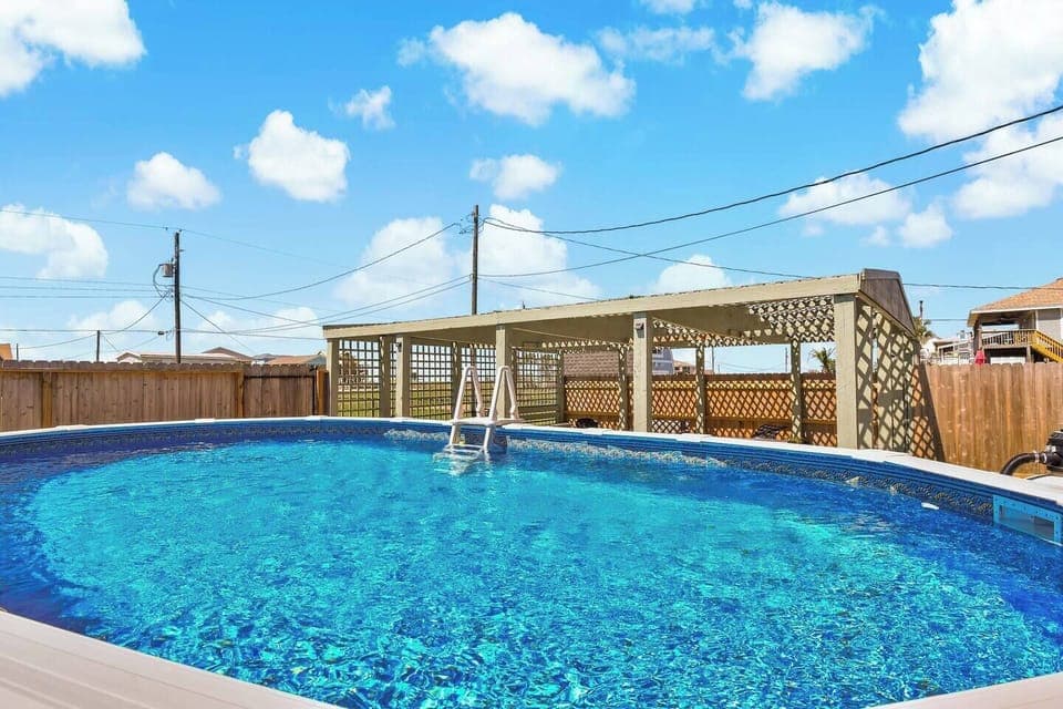 Pool Paradise: Dive into fun in this sparkling pool with sunny skies above! Perfect for relaxation.