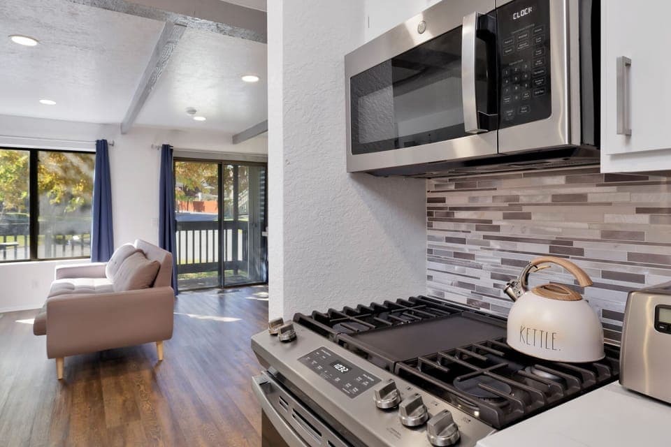 Fully equipped cabin kitchen with ample cabinetry, stove, fridge, microwave, and coffee maker—perfect for cooking meals, morning coffee, and feeling right at home on your stay.