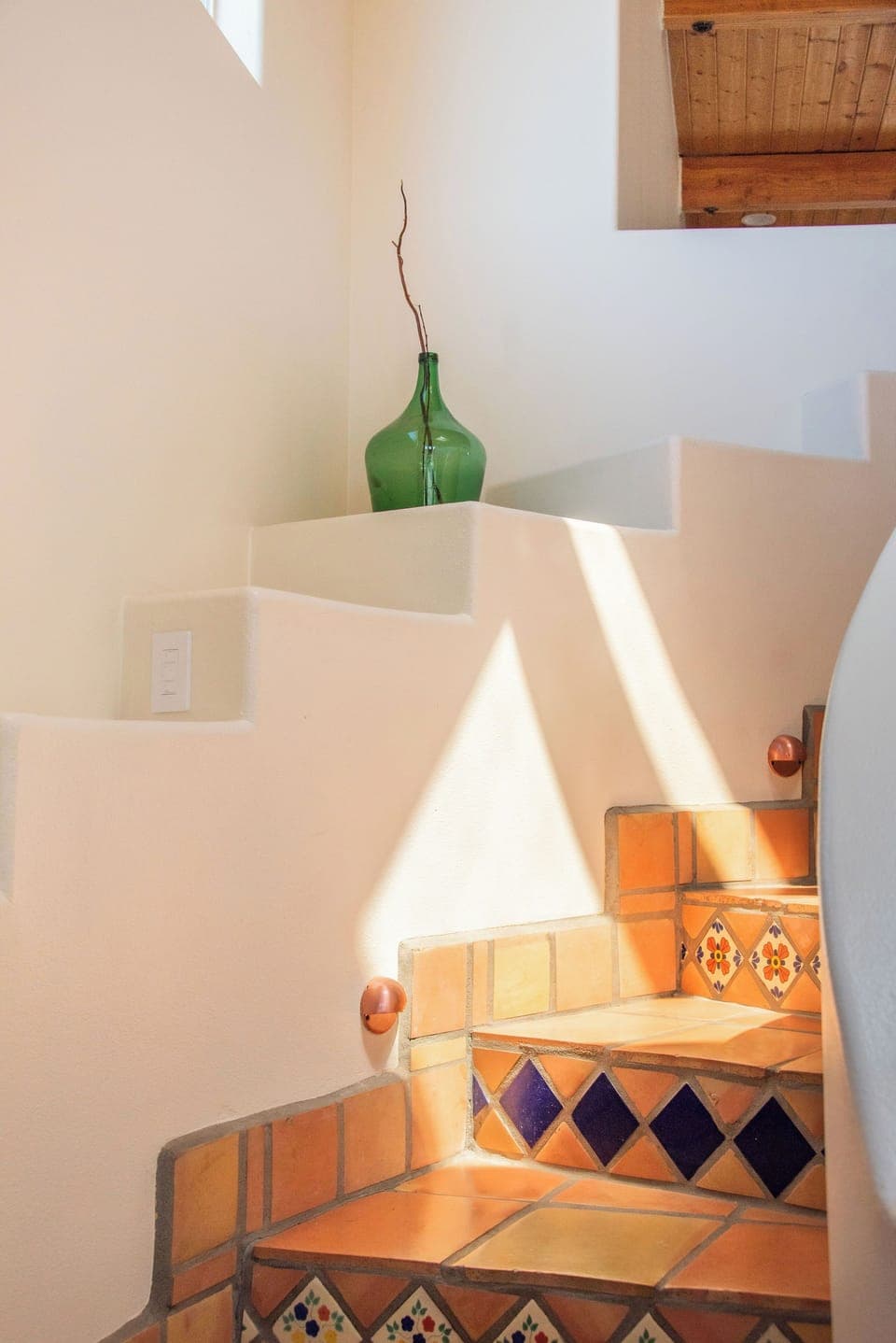 Spiral stairs leading to upstairs loft, 2 guest rooms, and rooftop patio