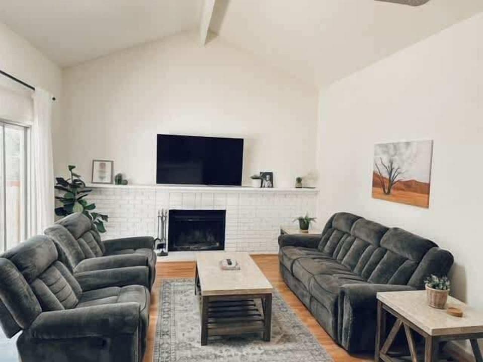 Gather in this cozy living room with vaulted ceilings, plush seating, and warm fireplace—perfect for movie nights or relaxing after a day of exploring. 