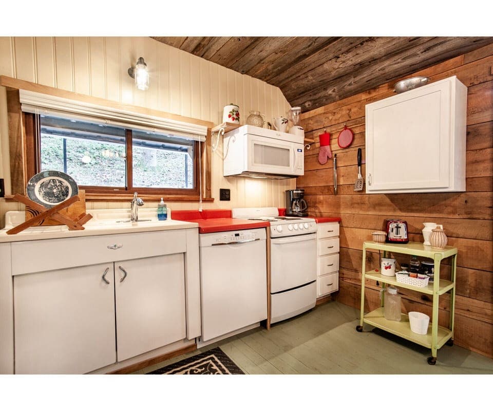 Step into this rustic kitchen retreat, where vintage charm meets modern convenience. From the wooden ceilings to the retro appliances, it’s a cozy space for any home chef.