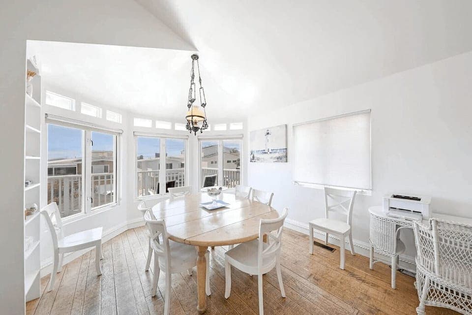 The dining area is bathed in light and surrounded by beachy accents. Table seats 6-8.
                