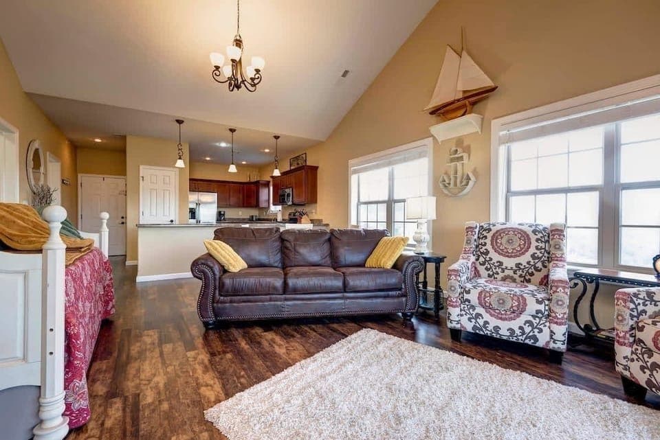 Large living room with sofa sleeper, 2 comfy chairs.