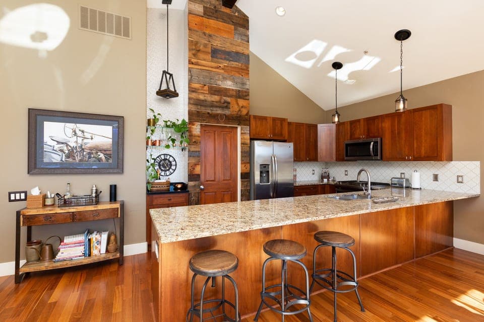 Rustic modern kitchen with dry bar and handsome accent lighting.