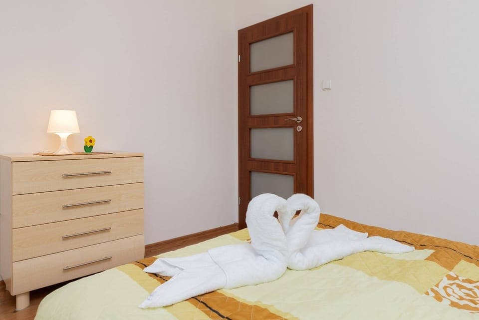 A close-up of a dresser and bedside lamp, adding a homey and practical touch to the room.
