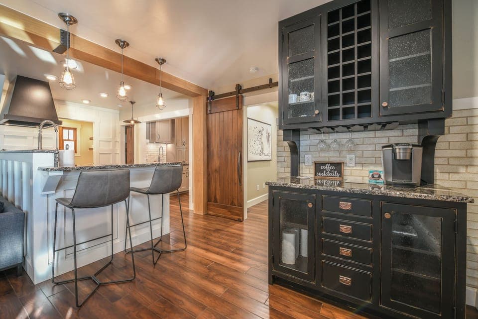 Gorgeous shot of the kitchen, coffee bar, and sliding solid wood barn doors. 