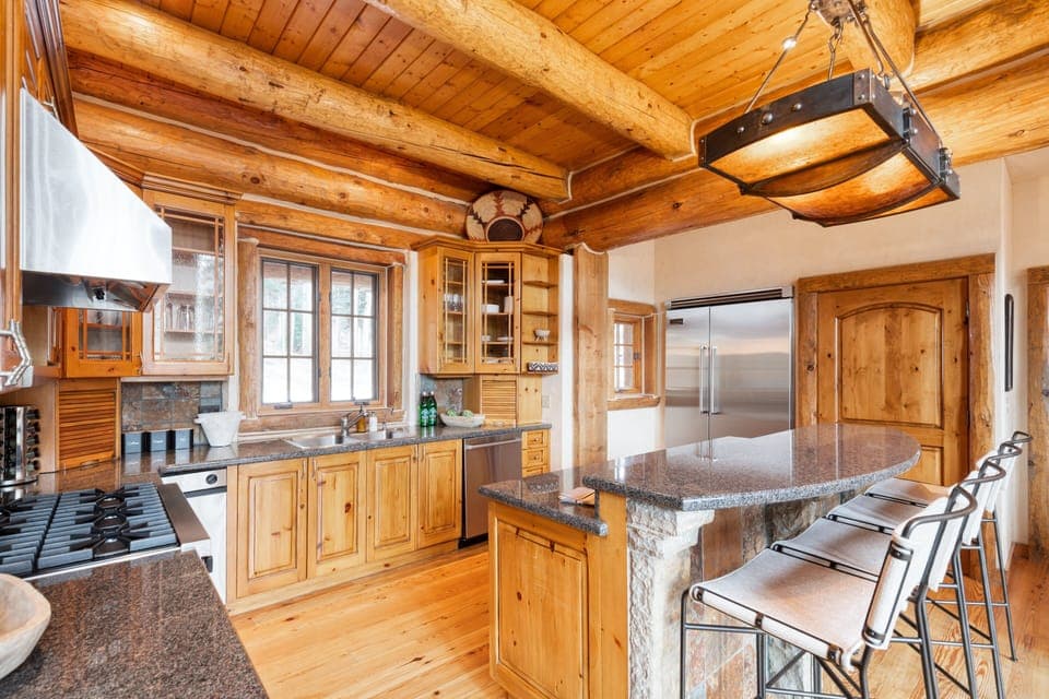 Kitchen features modern appliances and counter-top seating.