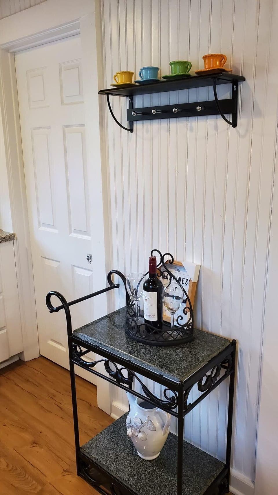 Teacart with complimentary bottle of wine, bottles of water, and fruit basket