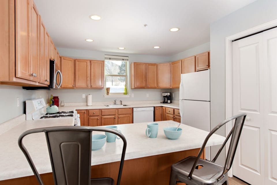 View from breakfast bar seating into kitchen 