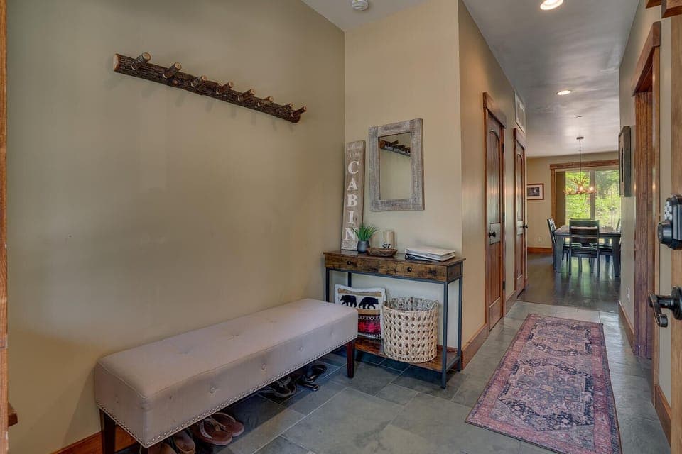 Entryway bench coat rack and shoe area.