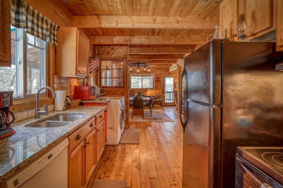 Full Kitchen with Fridge, Stove/ Oven, Coffee Makers, and Double Sink