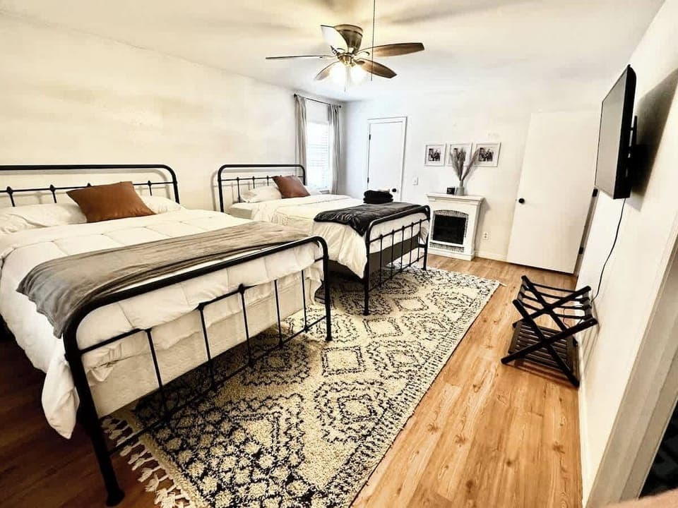 [Side B Bedroom 3] 2 Queen beds, electric fireplace, Roku tv, Netflix access, & private bathroom with stand up shower