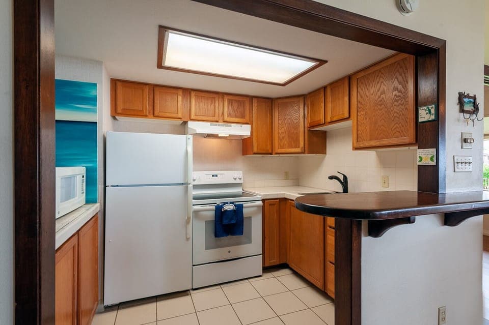 full kitchen - Everything you need to make your own meals is in the small but mighty kitchen! A full size fridge/freezer, microwave, toaster, drip coffee pot, pots/pans, dishes/utensils, and a small selection of basic cooking supplies.