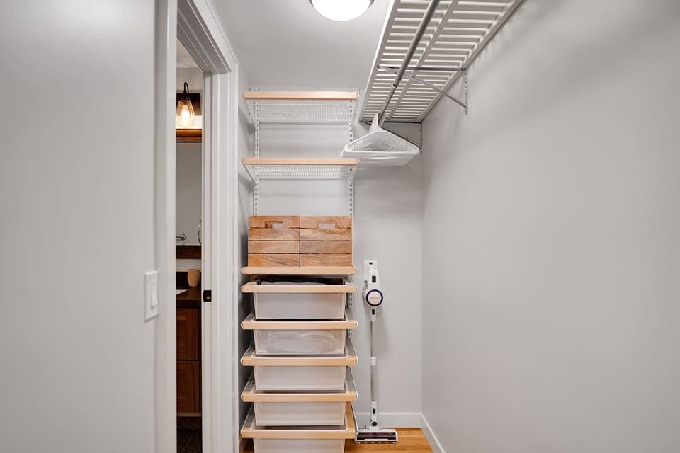 Large walk-in closet includes plenty of drawers, storage & work-out equipment.