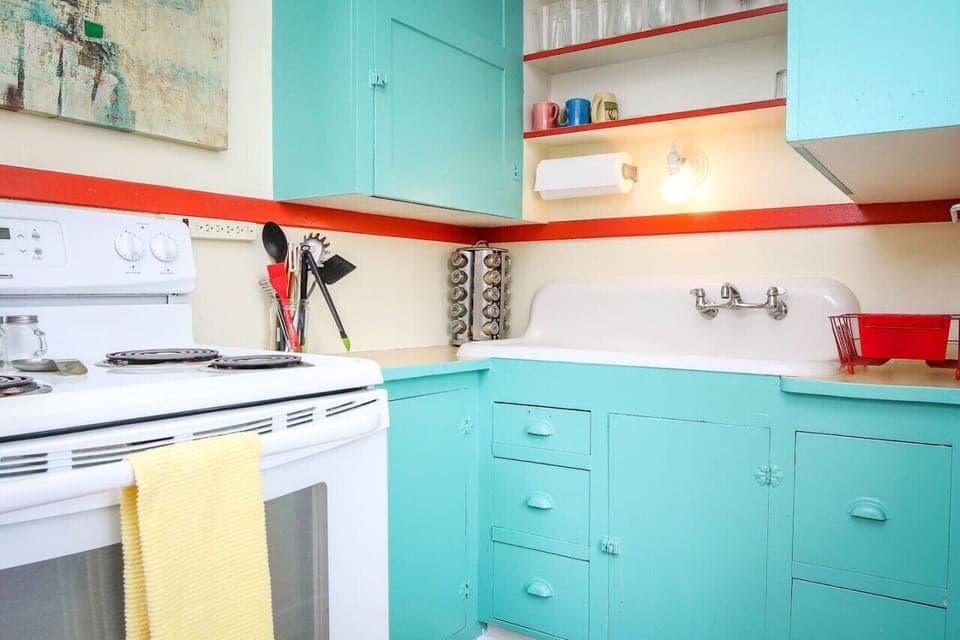 Darling kitchen with electric stove, microwave, Keurig, and an option to purchase wine.