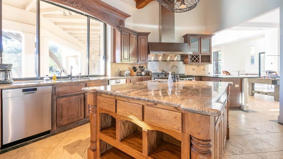 Spacious luxury kitchen w/ large center island, double sinks, & chef's range