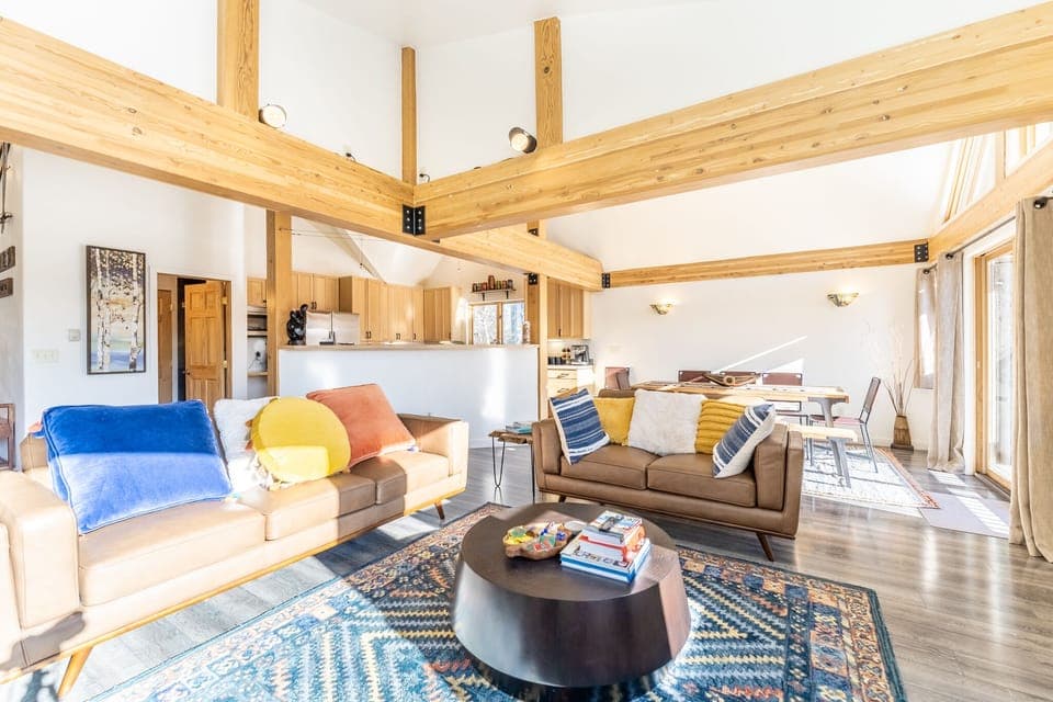 Spacious living area with panoramic windows, incredible light, flat screen TV, hardwood floors and ample seating.