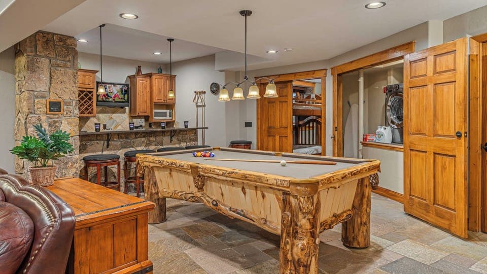 Lower level family room with billiards, bar, and laundry area