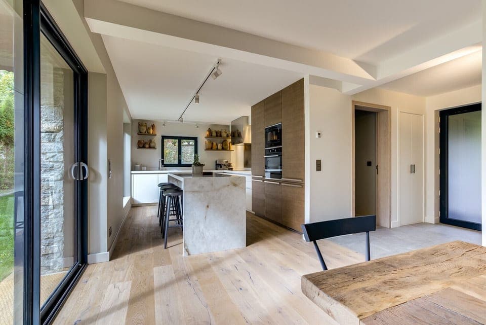 Kitchen with stone island with stools   