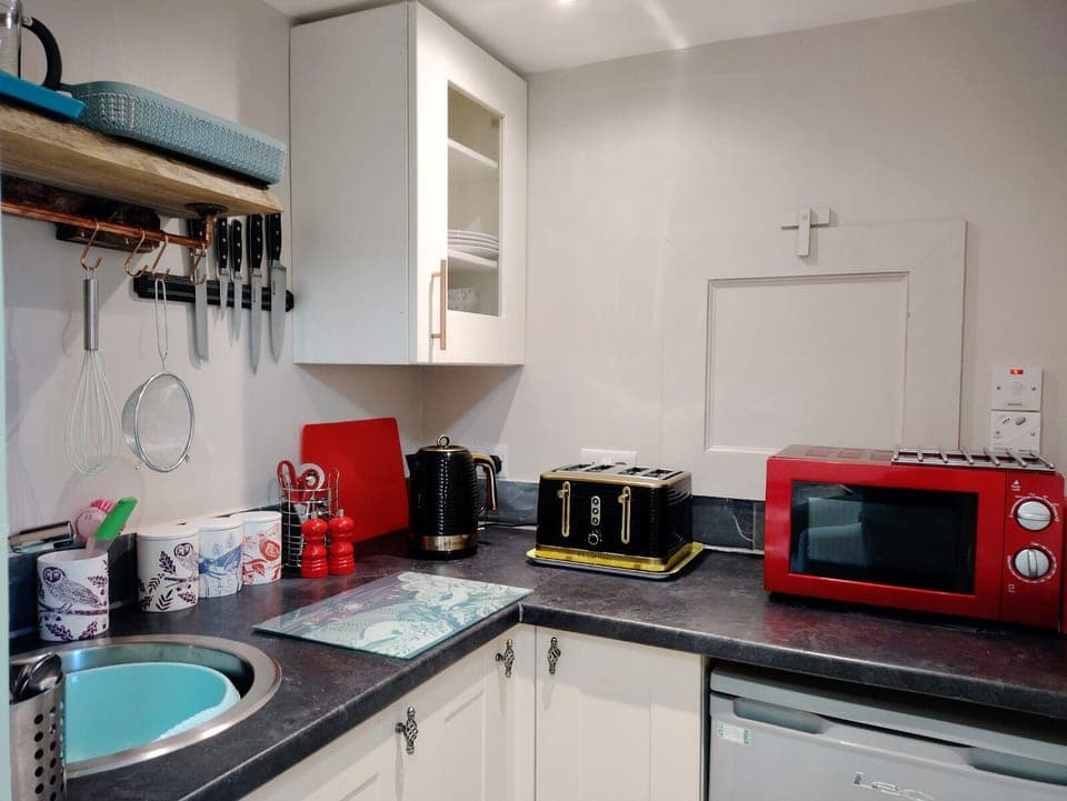 Kitchenette with kettle, toaster, microwave and fridge - please note no oven